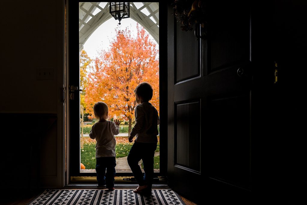 Charlotte Lifestyle Photographer also serving Mooresville, Davidson, Cornelius, Huntersville silhouette of brothers looking outside during Fall Family Photography
