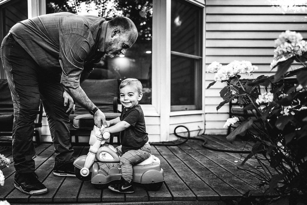 Charlotte Lifestyle Photographer also serving Mooresville Davidson Cornelius Huntersville specializes in family newborn branding natural fun moments backyard home session father and son playing black and white