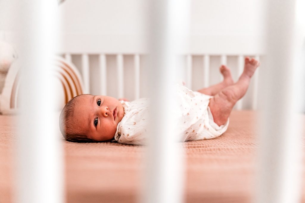 Newborn in crib feet up