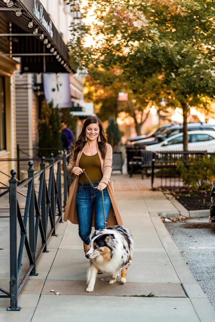 Woman walking dog in city
