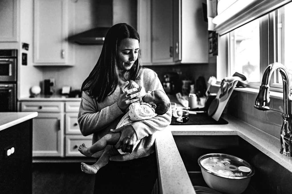 Mom feeding baby in kitchen