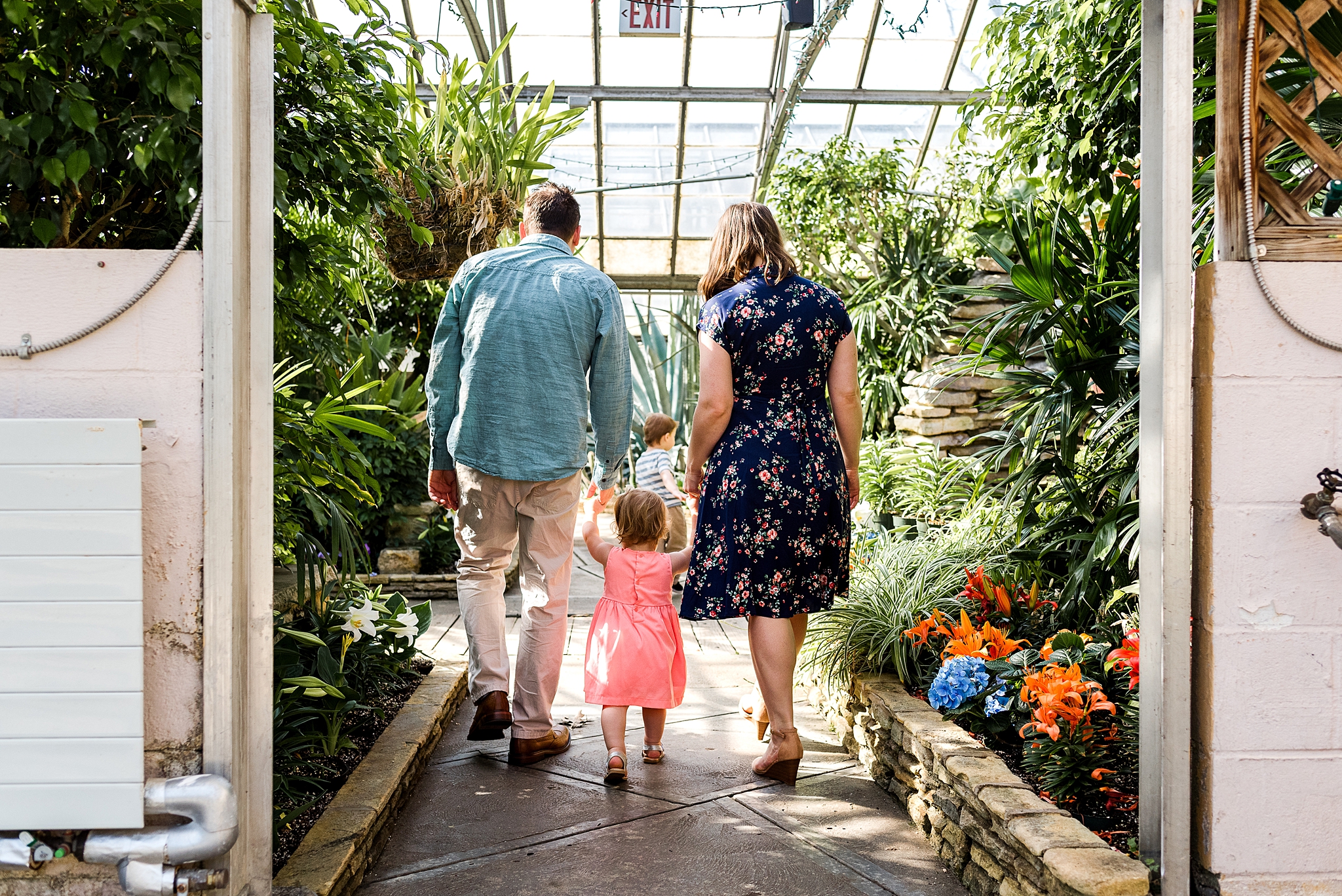 family walking through a greenhouse